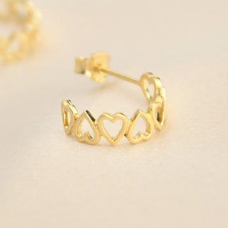 Gold open heart hoop earrings shown close up 