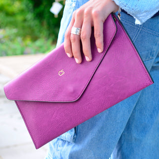 pink purple leather envelope clutch bag with gold initials monogrammed on the front personalised