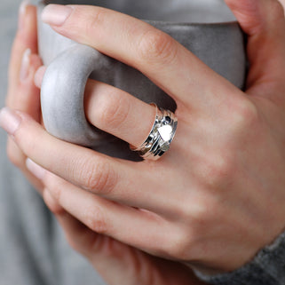 Cherish Sterling Silver Heart and Gemstone Spinning Ring shown being worn on models hand.