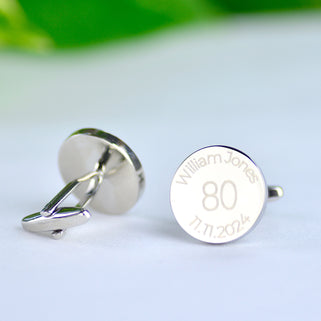 Personalised milestone 80th birthday cufflinks with "William Jones" engraved around the top and "11.11.2024" engraved around the bottom shown in close up shot with left cufflink facing the other way