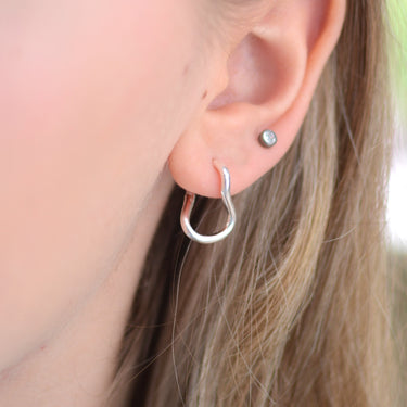 Sterling Silver Organic Twist Hoop Earrings shown close up on model