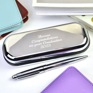 Silver chrome pen with matching case with "Thomas Congratulations on your Graduation 2023" engraved in script font shown close up shot