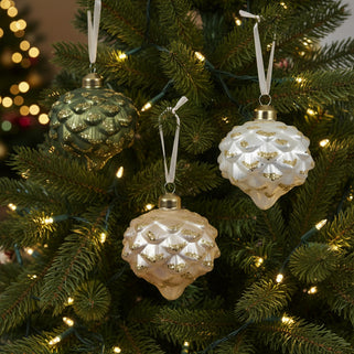 Three glittery bauble ornaments in different colors, featuring an onion-shaped design with gold glitter detailing, hanging from silver ribbons.