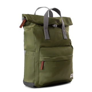 An olive green roll-top backpack with gray webbing handles, a front zippered pocket, and small brown leather zipper pulls, shown on a plain white background.