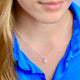Sparkle Tiny Initial R Necklace shown on model close up