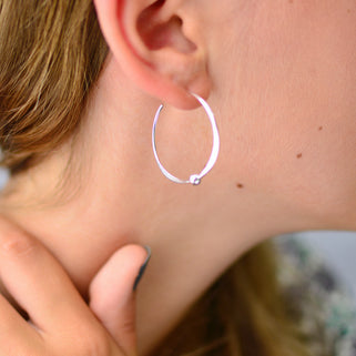 Sterling Silver large Hoop Earrings With Beads shown close up on model.