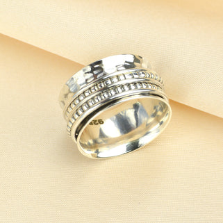 Hammered Sterling Silver Beaded band Spinning Ring shown close up with hallmark.