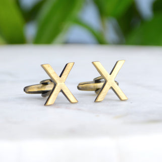 brass kiss cufflinks shown in close up shot