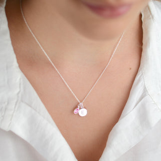 Personalised Silver Initial Teardrop Birthstone Necklace shown close up on model with October birthstone