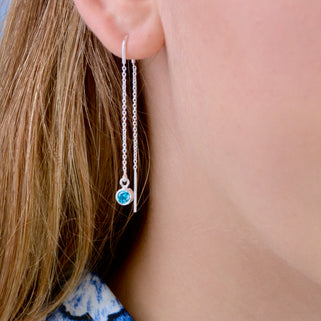 Sterling Silver birthstone threader shown close up on model with blue topaz/December birthstone charm