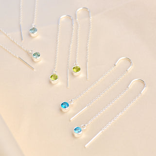 Sterling Silver birthstone threaders shown close up  with aquamarine, peridot and blue topaz birthstones