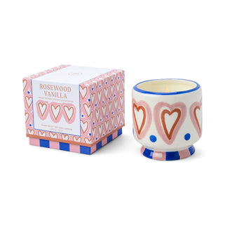 Ceramic candle with heart design and matching box on a white background