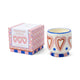 Ceramic candle with heart design and matching box on a white background