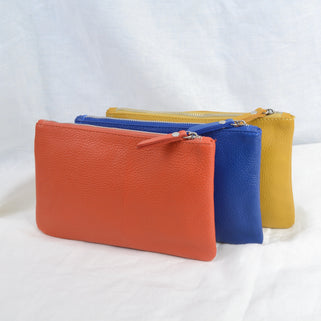 Personalised Small Leather Cosmetics Bag showing orange, cobalt and mustard colour choices