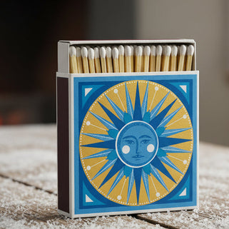 Matches box with sun design on a wooden surface