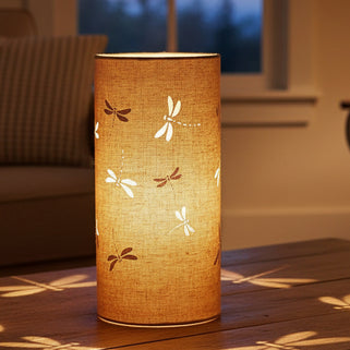 Cylindrical lamp with dragonfly designs on a blue background