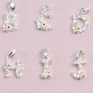 Close up of flower letter charms