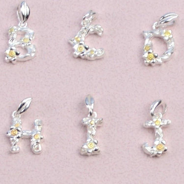 Close up of flower letter charms