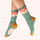 Green socks with fox design worn by a person on a white background