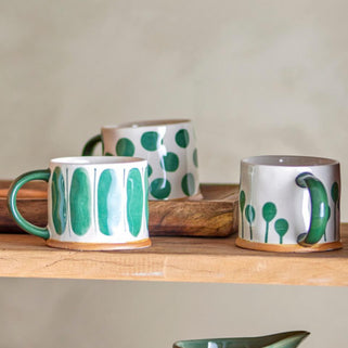 Linora Mug Green, shown in assorted designs in lifestyle setting.