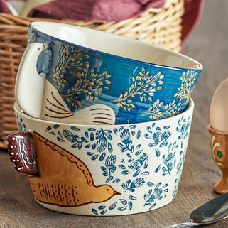 hand painted blue bird bowl shown in lifestyle shot on kitchen table