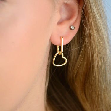 Gold Heart Shape Drop Hoop Earrings shown close up on model