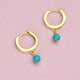 14 carat Gold Vermeil Turquoise Dangle Huggie Earrings shown close up