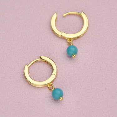 14 carat Gold Vermeil Turquoise Dangle Huggie Earrings shown close up