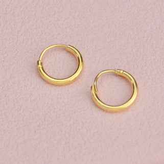 Simple Gold Sleeper Huggie Hoop Earrings shown close up