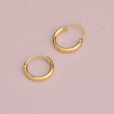 Simple Gold Sleeper Huggie Hoop Earrings shown close up