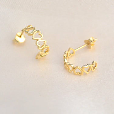 Gold open heart hoop earrings shown close up