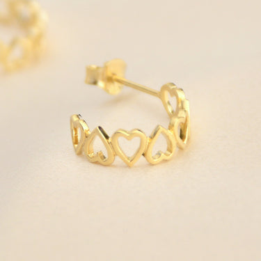 Gold open heart hoop earrings shown close up 