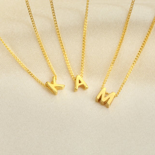 Personalised Gold Mini Slider Initial Charm Necklace letter K A and M shown close up
