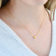 Personalised Gold Mini Slider Initial Charm Necklace shown close up on model - letter M on 16