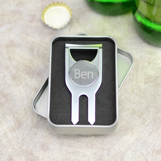 Personalised golf marker and bottle opener shown close up in polished silver finish in presented tin