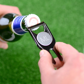 Personalised golf marker and bottle opener shown close up in gunmetal finish