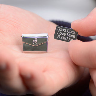 Good luck pin badge with "Good Luck! Love Mum & Dad xx" engraved on letter and fingers crossed icon engraved on envelope