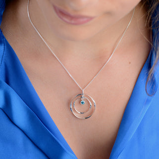 Personalised Silver Halo Circle Birthstone Necklace with December birthstone shown close up on model