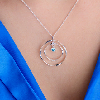 Personalised Silver Halo Circle Birthstone Necklace with December birthstone shown close up on model