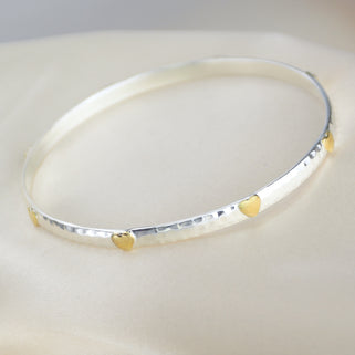 Sterling Silver Mia Hearts Bangle showing brass heart details