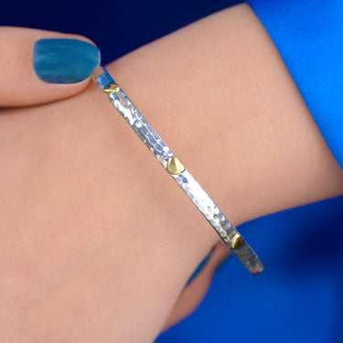 Sterling Silver Mia Hearts Bangle shown close up on model