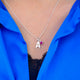 Modern initial and birthstone necklace with letter A and October birthstone on 16