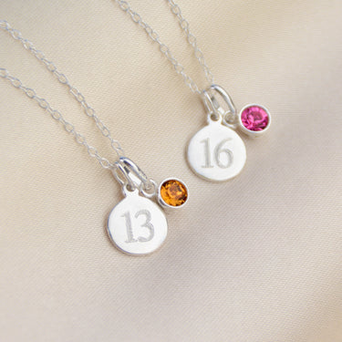Silver landmark birthstone necklace shown close up with Citrine and Toumaline birthstone charms