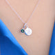 Silver landmark birthstone necklace shown close up on model