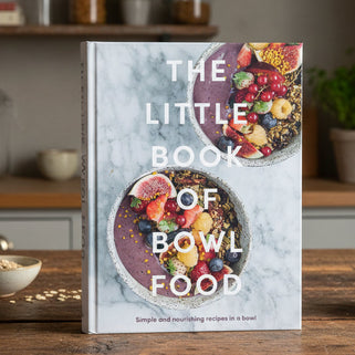 Book cover of 'The Little Book of Bowl Food' with two bowls of fruit and granola on a marble background.