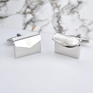 Envelope cufflinks with lucky clover engraved on the front of both cufflinks, shown in close up shot.