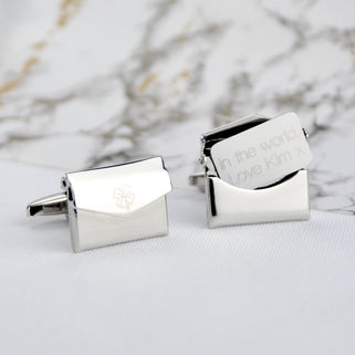 Lucky charm hidden message cufflinks with 4 leaf clover engraved on the front of the left cufflink and "in the world, Love Kim x" shown engraved on the letter of the right cufflink