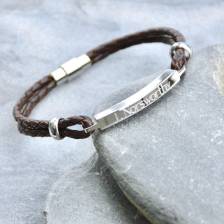 Personalised Men's Leather Slim Bar Bracelet shown in brown leather close up .