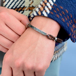 Personalised Men's Leather Slim Bar Bracelet shown in brown leather close up on model.