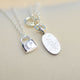 Mini moon and padlock necklace with engraved oval disc al shown close up.